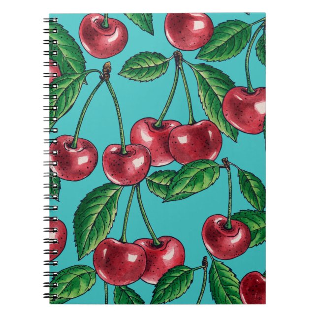 Red cherries on turquoise notebook (Front)
