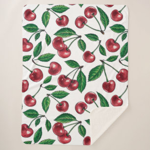 Red cherries on white sherpa blanket