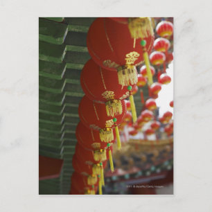 Red Chinese lanterns hanging from temple Postcard