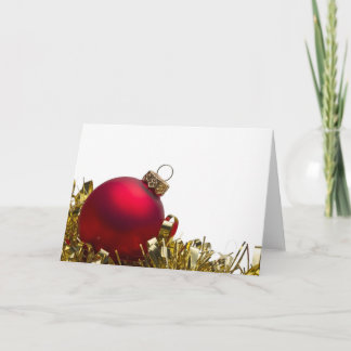 Red Christmas bauble and gold tinsel on white Holiday Card
