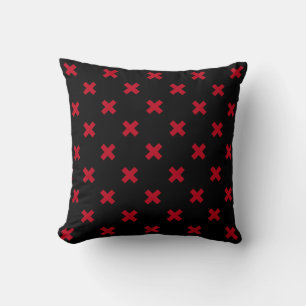 Red cross stitches on black cushion