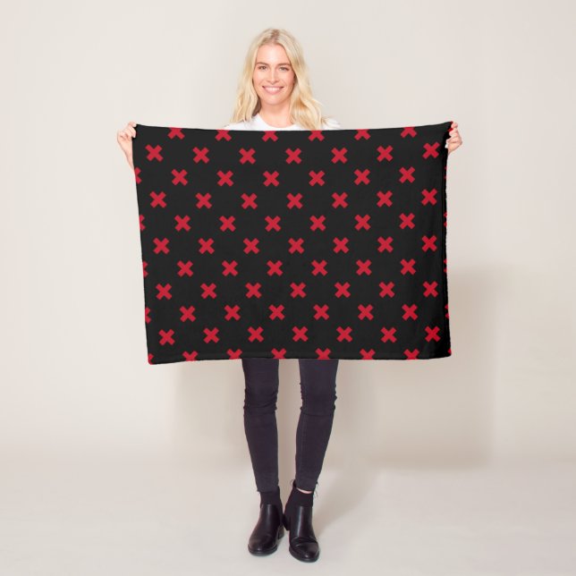 Red cross stitches on black fleece blanket (In Situ)