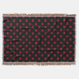 Red cross stitches on black throw blanket