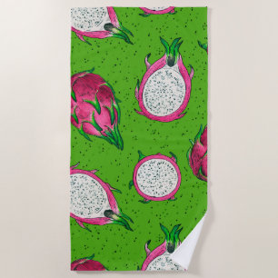 Red dragon fruit on green beach towel