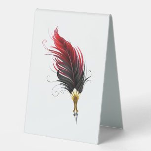 Red feather pen with gold nib