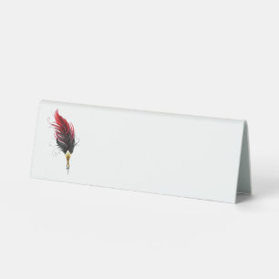 Red feather pen with gold nib