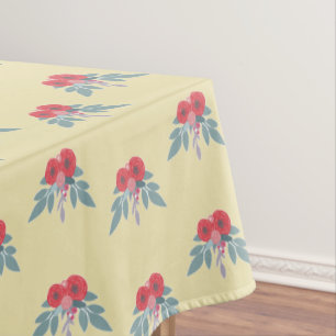 Red flowers and green leaves on brown tablecloth