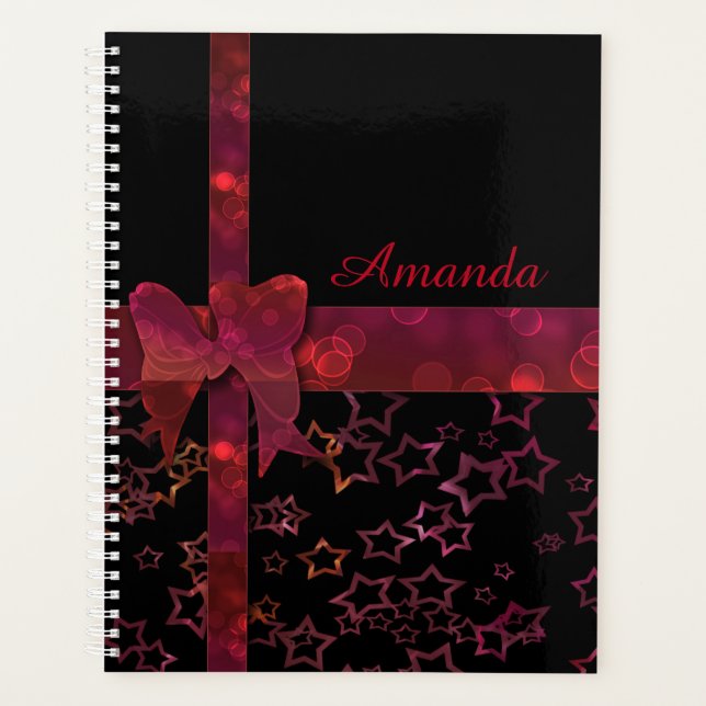 Red glitter bow and stars on black planner (Front)