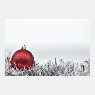 Red glittery Christmas ornament and silver tinsel