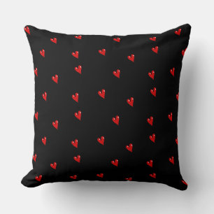Red glossy hearts on black cushion