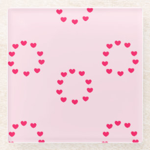 Red heart circles on pink glass coaster