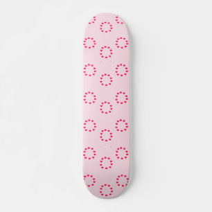 Red heart circles on pink skateboard