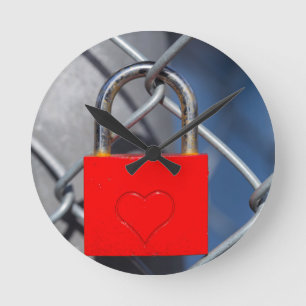 Red heart lock on fence round clock