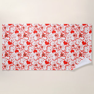 Red hearts and flowers on a white beach towel