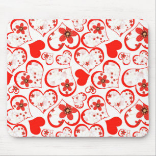 Red hearts and flowers on a white mouse pad