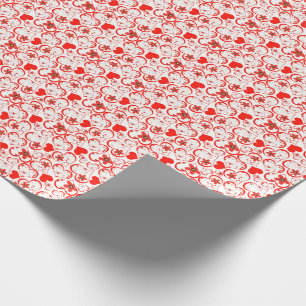 Red hearts and flowers on a white wrapping paper