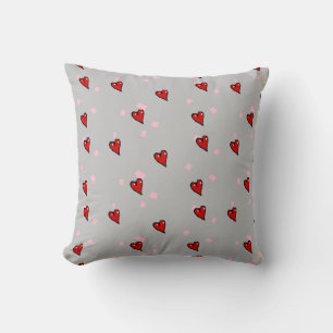 Red hearts on grey cushion