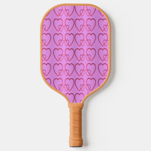 Red hearts on pink pickleball paddle