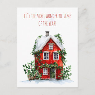 Red house adorned with snow and greenery holiday postcard