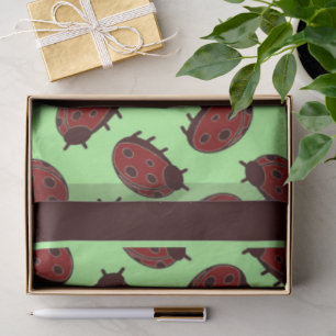 Red ladybugs on green tissue paper