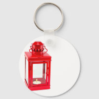 Red lantern with burning tealight on white
