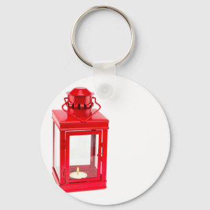 Red lantern with burning tealight on white key ring