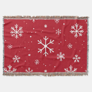 Red pillow with white snowflake pattern throw blanket