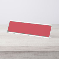 Red, pink, and orange garments hang side by side o