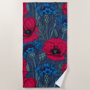 Red poppies and blue cornflowers on blue beach towel