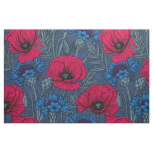 Red poppies and blue cornflowers on blue fabric