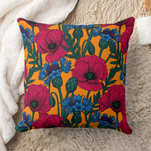 Red poppies and blue cornflowers on orange cushion