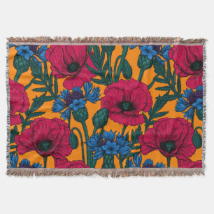 Red poppies and blue cornflowers on orange throw blanket