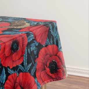 Red poppies and wrens, blue leaves on black tablecloth
