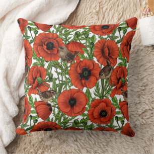 Red poppies and wrens, green leaves on white cushion