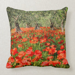 Red poppy flowers under old olive trees cushion