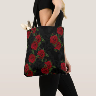 Red roses on a black background tote bag