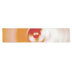 Red spinning music speaker short table runner