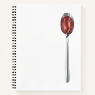 Red syrup in silver spoon notebook