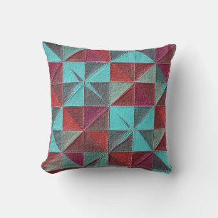 red, teal, purple, and gray quilt cushion