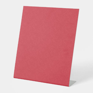 Red textured surface with subtle swirling pattern pedestal sign