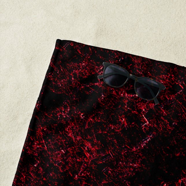 Red thick sponge upon dark red background beach towel (In Situ)