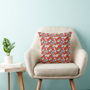 Red throw pillow with white and blue flowers