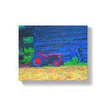Red tractor in front of barn
