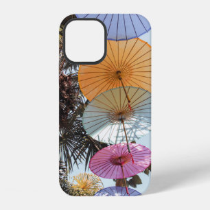 Red umbrella on green tree iPhone 12 case