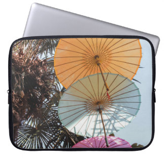Red umbrella on green tree laptop sleeve