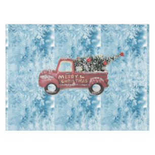 red vintage truck on a blue snowflake background tablecloth