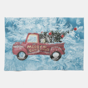 red vintage truck on a blue snowflake background tea towel