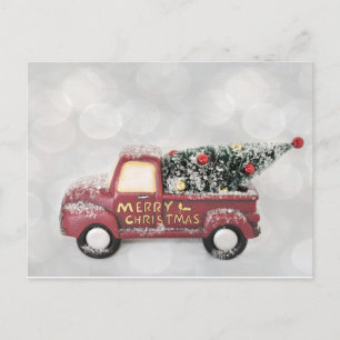 red vintage truck on a grey bokeh background postcard