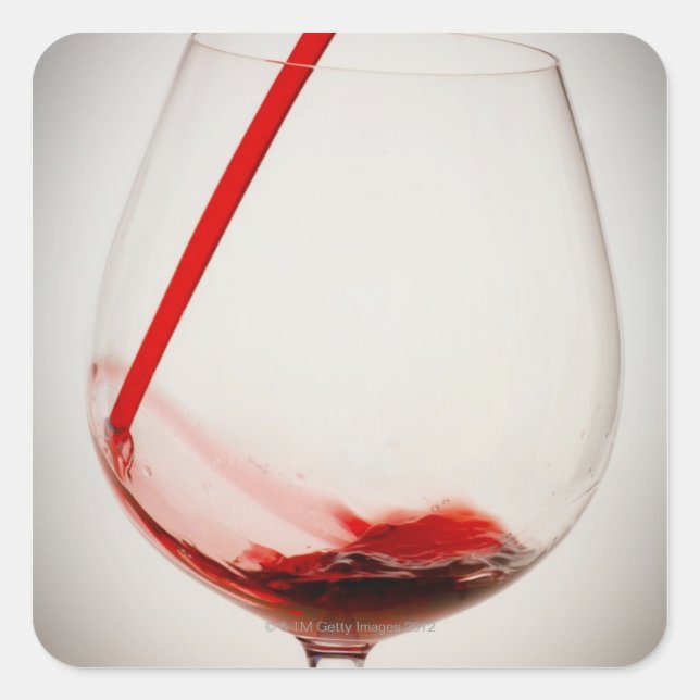 Red wine pouring into glass, close-up square sticker (Front)