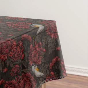 Redstarts in the chrysanthemums in brown and red tablecloth